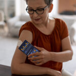 high-angle-woman-checking-glucose-levels