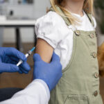 male-pediatrician-administering-vaccine-his-office